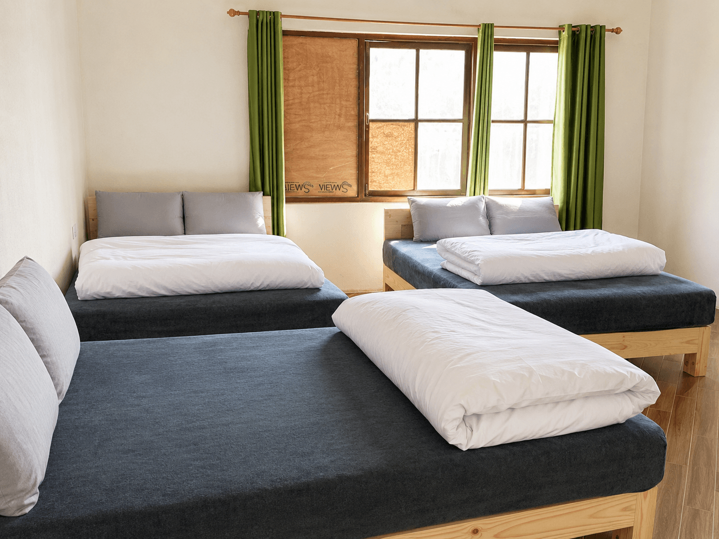 Three bed room with green curtains